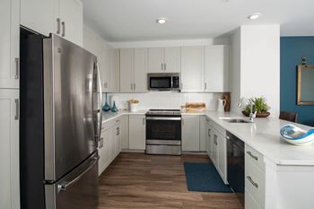 Custom kitchens finished with luxe quartz countertops and herringbone tile backsplashes, and outfitted with top-of-the line ge® stainless steel appliances